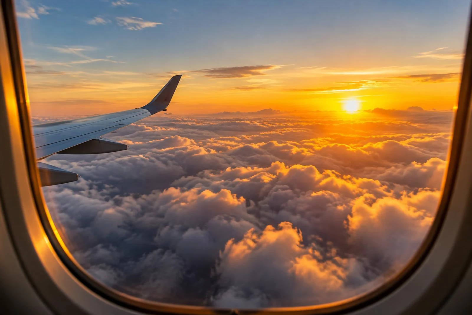 Airplane window view over clouds